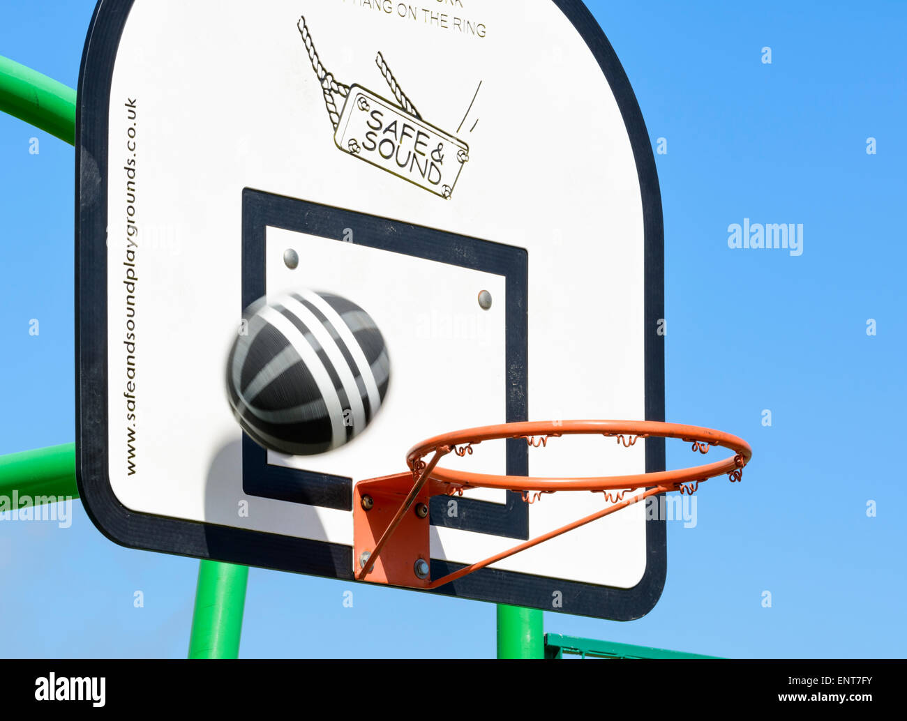 Basketball through at a hoop and missing Stock Photo Alamy