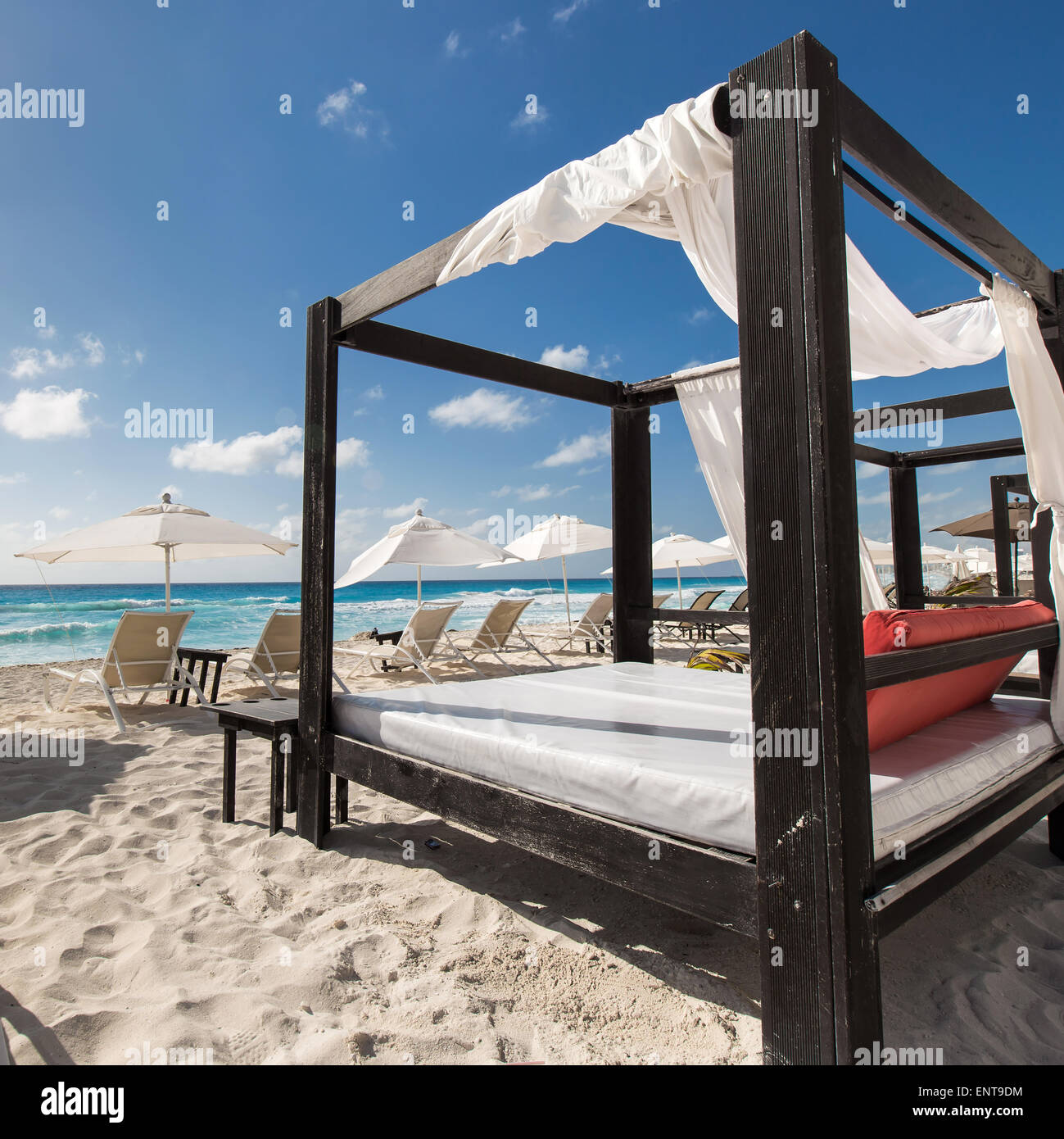 Luxury wooden lounge beds on a beautiful caribbean beach Stock Photo