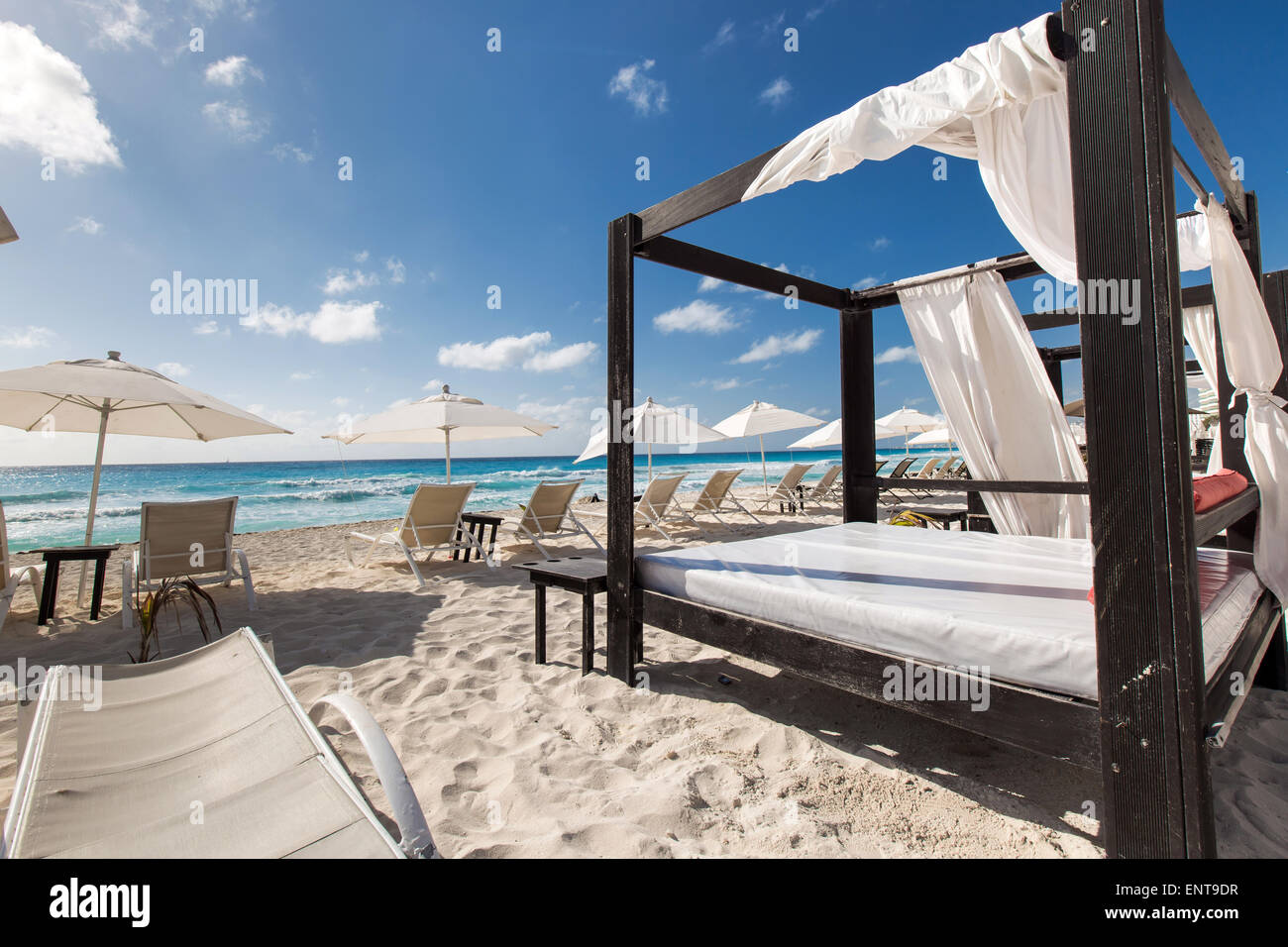 Luxury wooden lounge beds on a beautiful caribbean beach Stock Photo
