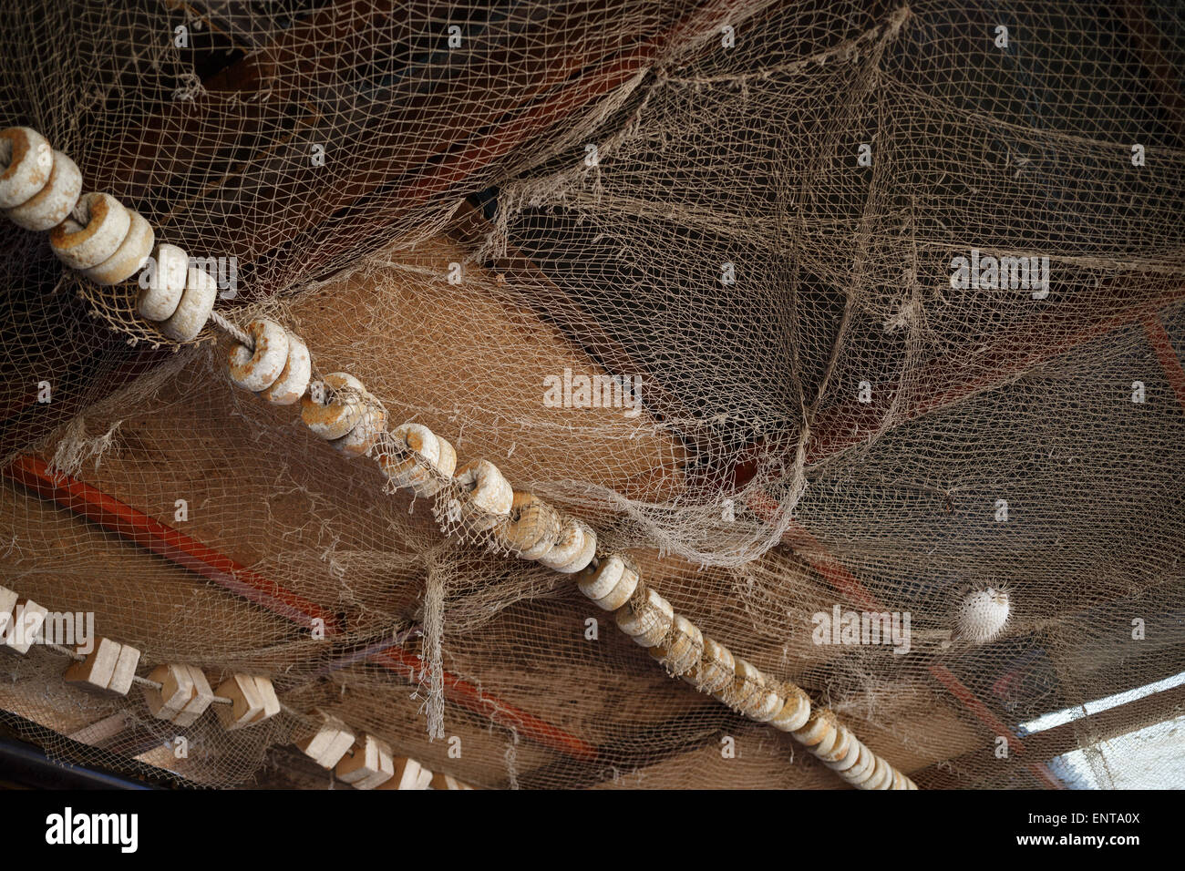 Old fishing net with floats, hanging from the ceiling. Shallow depth of  field Stock Photo - Alamy