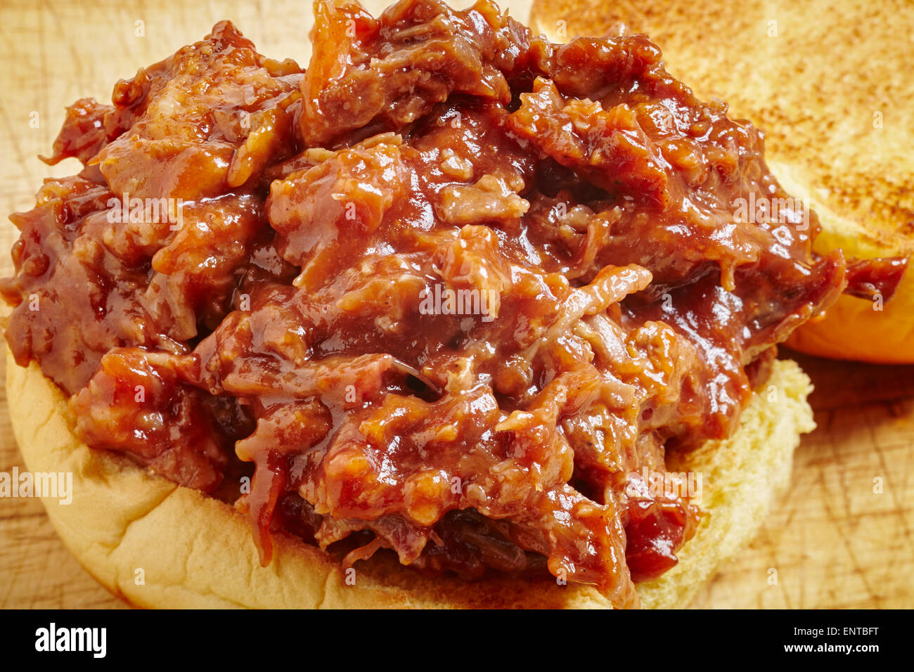 Pulled pork, a tradition food from the southern United States. It's Served here on a burger bun, a common way to eat it today. Stock Photo