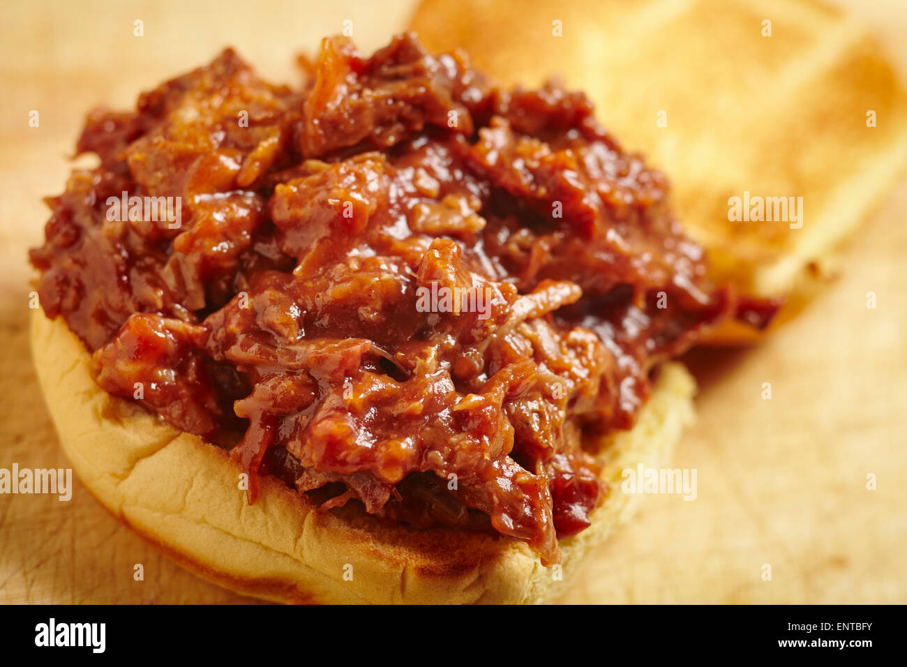 Pulled pork, a tradition food from the southern United States. It's Served here on a burger bun, a common way to eat it today. Stock Photo