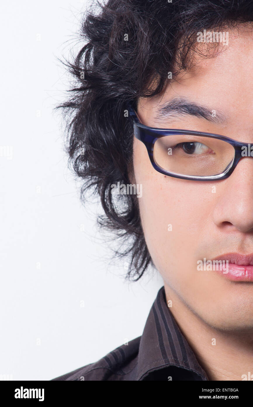 Asian young man wearing glasses looking away cropped Stock Photo