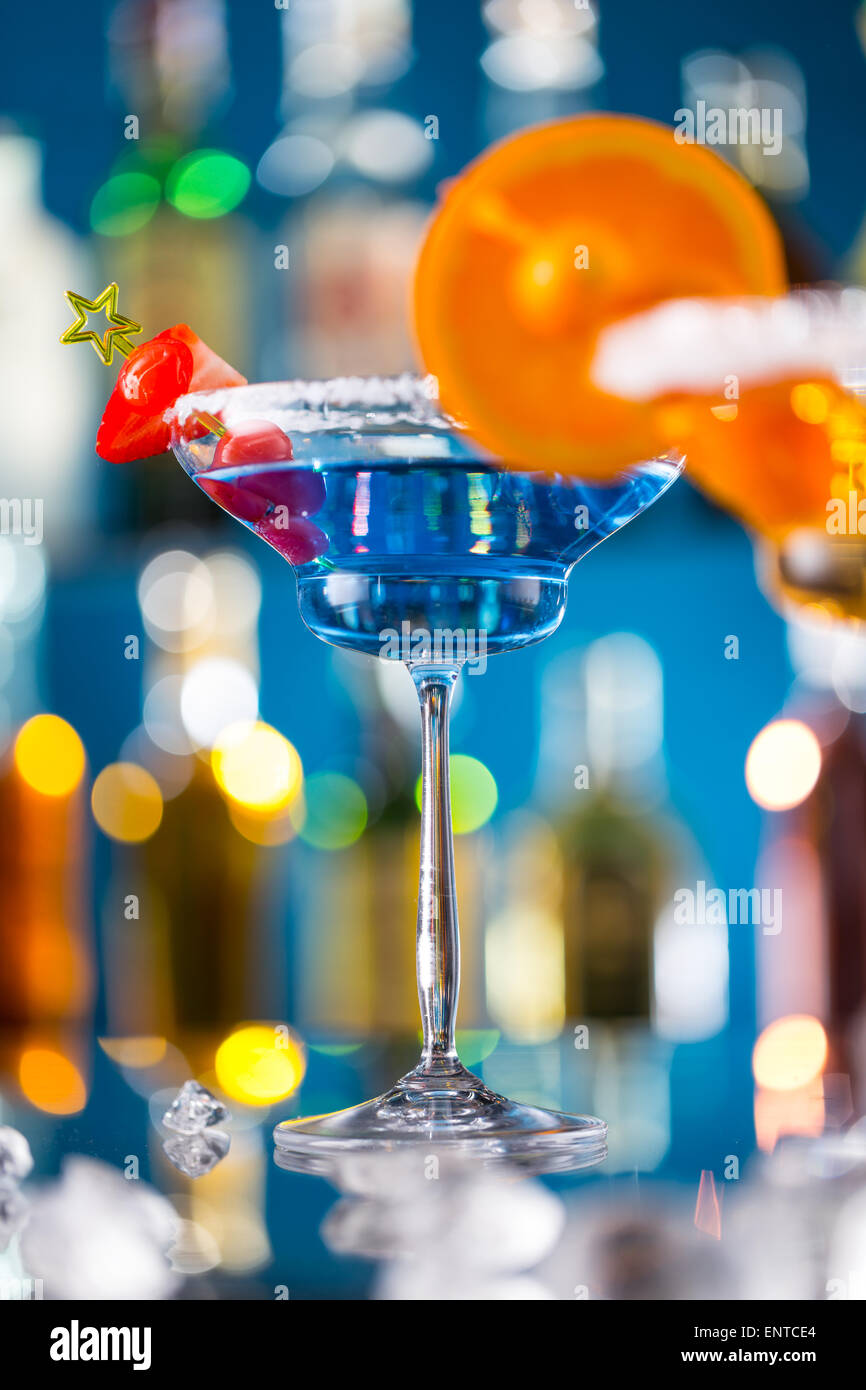 Martini drink served on bar counter with blur bottles on background Stock Photo