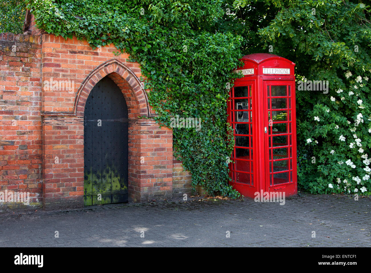 Red phonebox and ancient gate, Lichfield, England Stock Photo