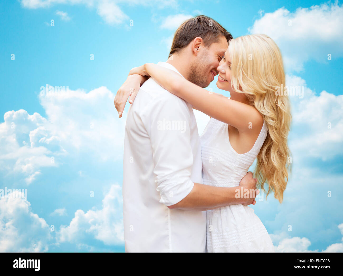 happy couple hugging over blue sky Stock Photo - Alamy