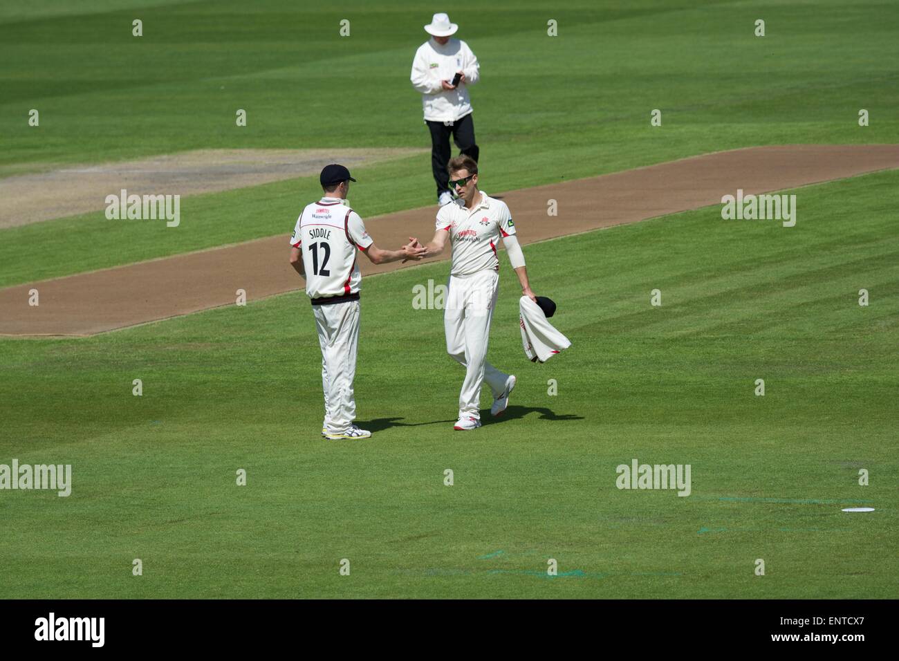 Old Trafford, Manchester, UK. 11th May, 2015. Peter Siddle congratulates Kyle Jarvis (Lancs) on taking the final wicket of the Gloucestershire innings. Jarvis finishes with figures of 4 for 121. County Cricket Lancashire v Gloucestershire Day 2 Credit:  John Fryer/Alamy Live News Stock Photo