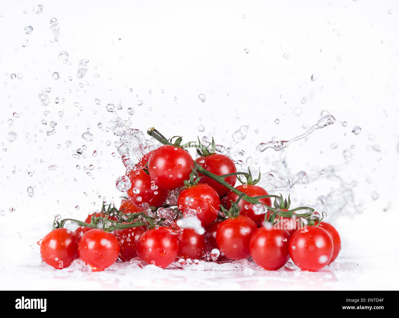 Fresh cherry tomatoes with water splash isolated on white background ...
