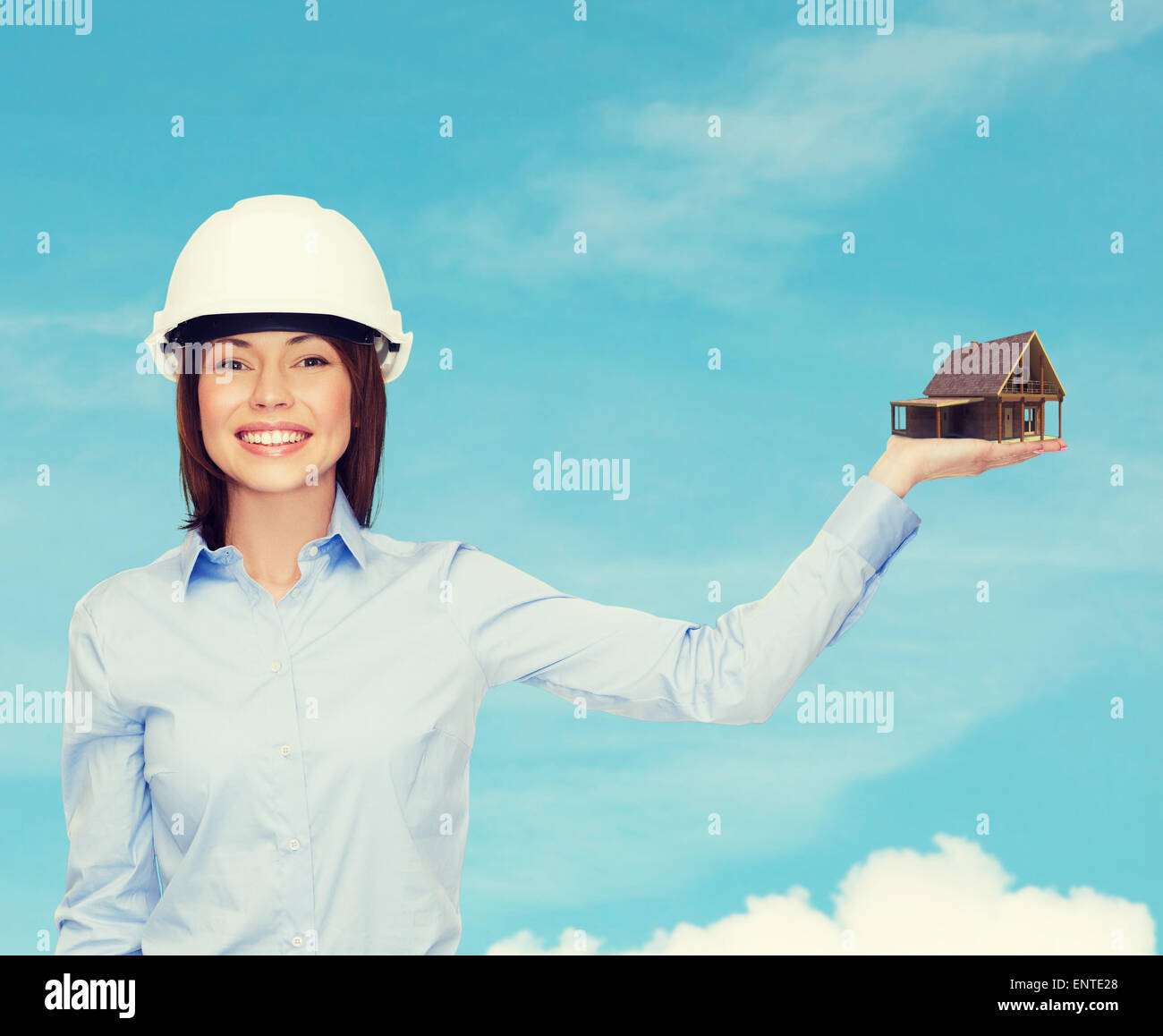 businesswoman in helmet holding house on palm Stock Photo - Alamy