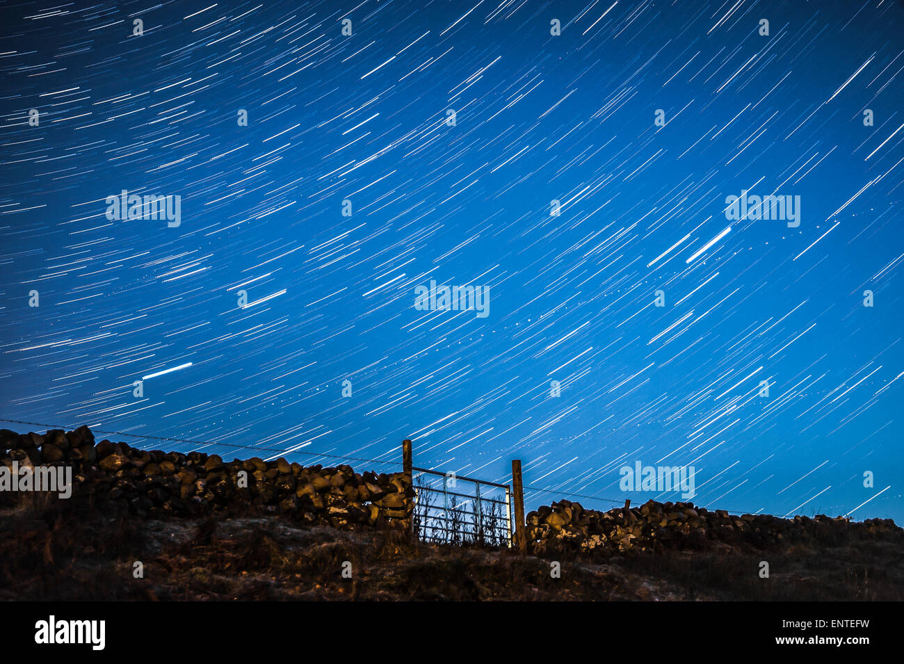 Stars, star trail in the night sky - starry sky in the dark, UK Stock Photo