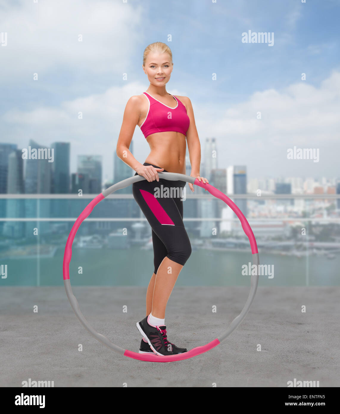 young sporty woman with hula hoop Stock Photo