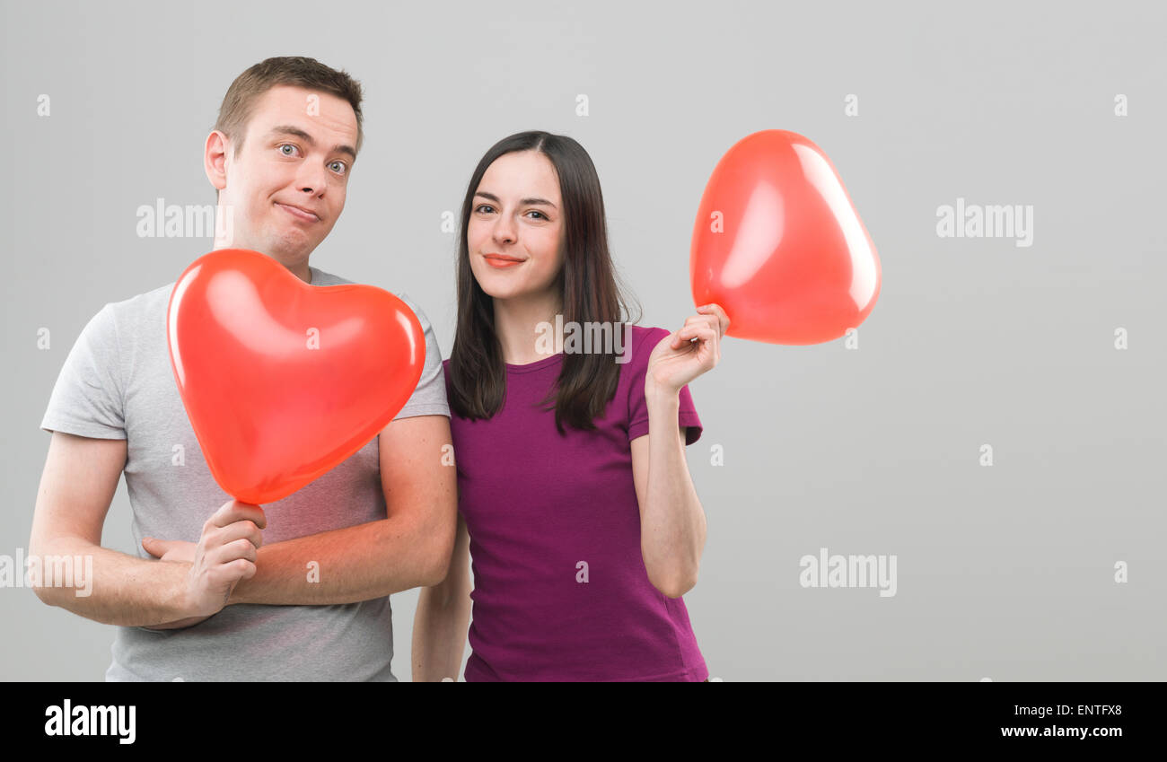 loving young couple holding heart shaped balloons and smiling. copy ...