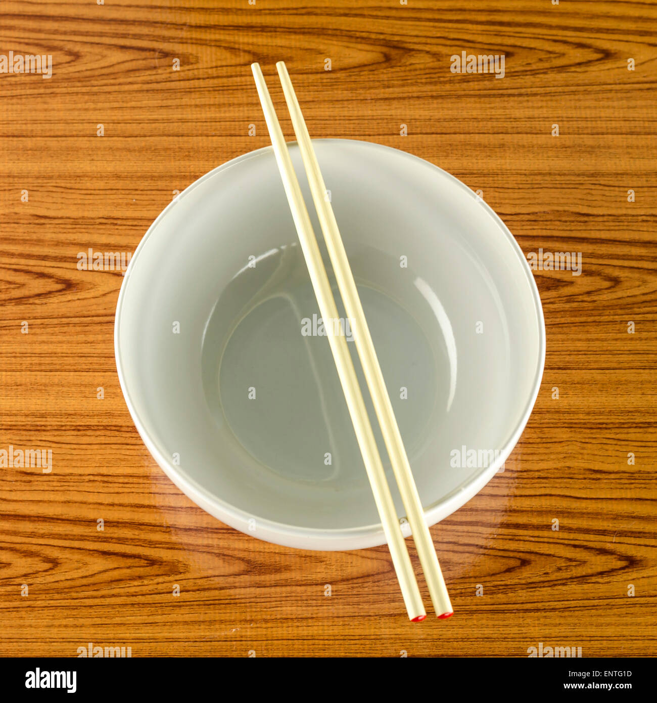 empty white bowl with chopstick on wood table background Stock Photo