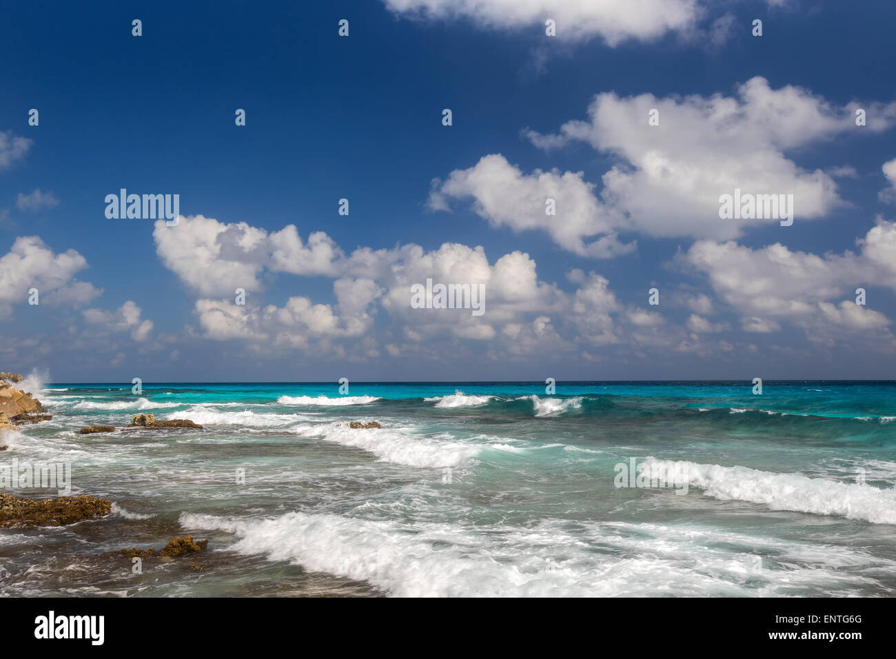 Ocean with waves and rocks on caribbean beach Stock Photo