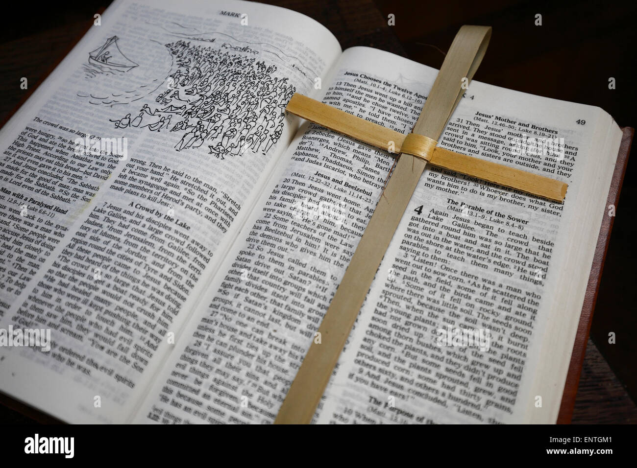 An open bible with a cross seen inside a parish church. Stock Photo