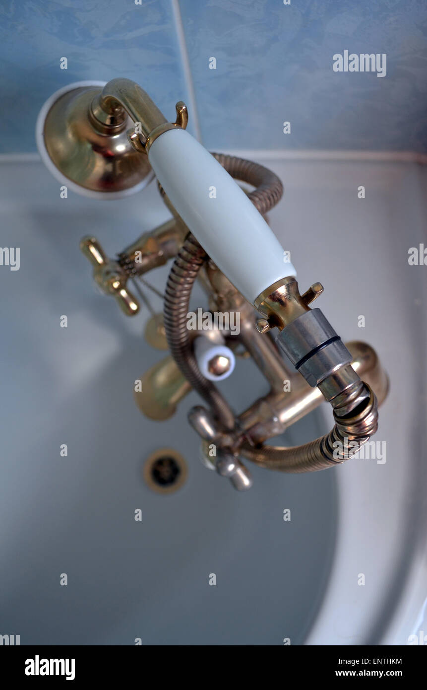 Old brass coloured mixer bath taps due to be replaced after 15 years