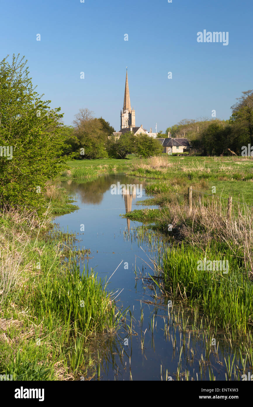 Burford church reflected in stream, Burford, Cotswolds, Oxfordshire, England, United Kingdom, Europe Stock Photo