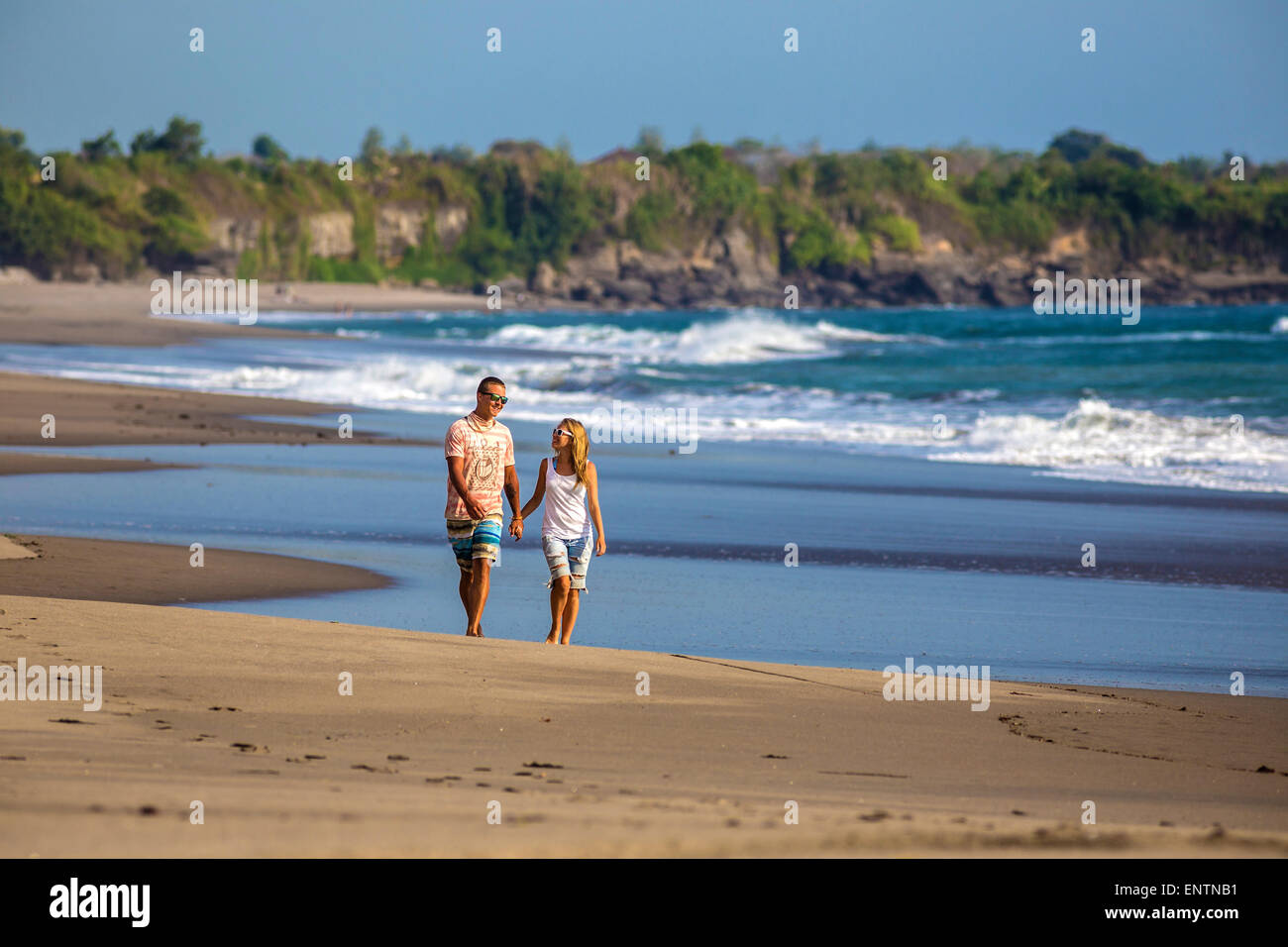 Couple are walking on the beach in Bali. Indonesia Stock Photo