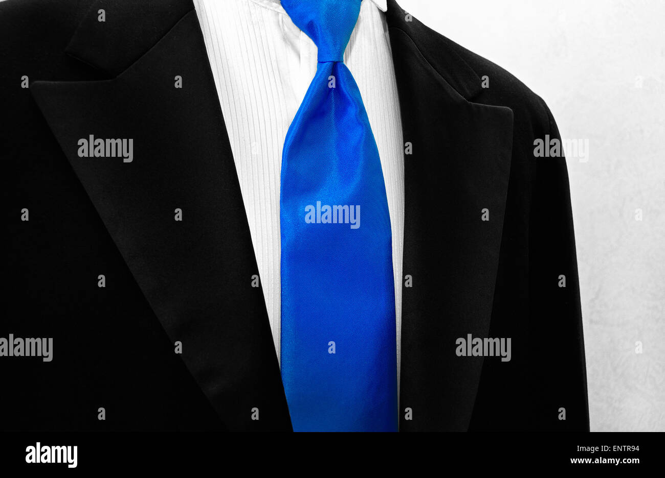 Bright blue satin tie accenting a black tuxedo. Stock Photo