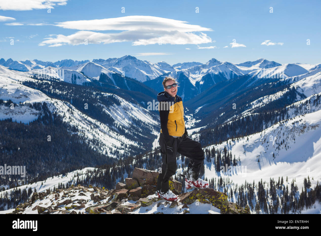 A woman laughs with joy on Trico Peak above Red Mountain Pass, San Juan National Forest, Colorado. Stock Photo