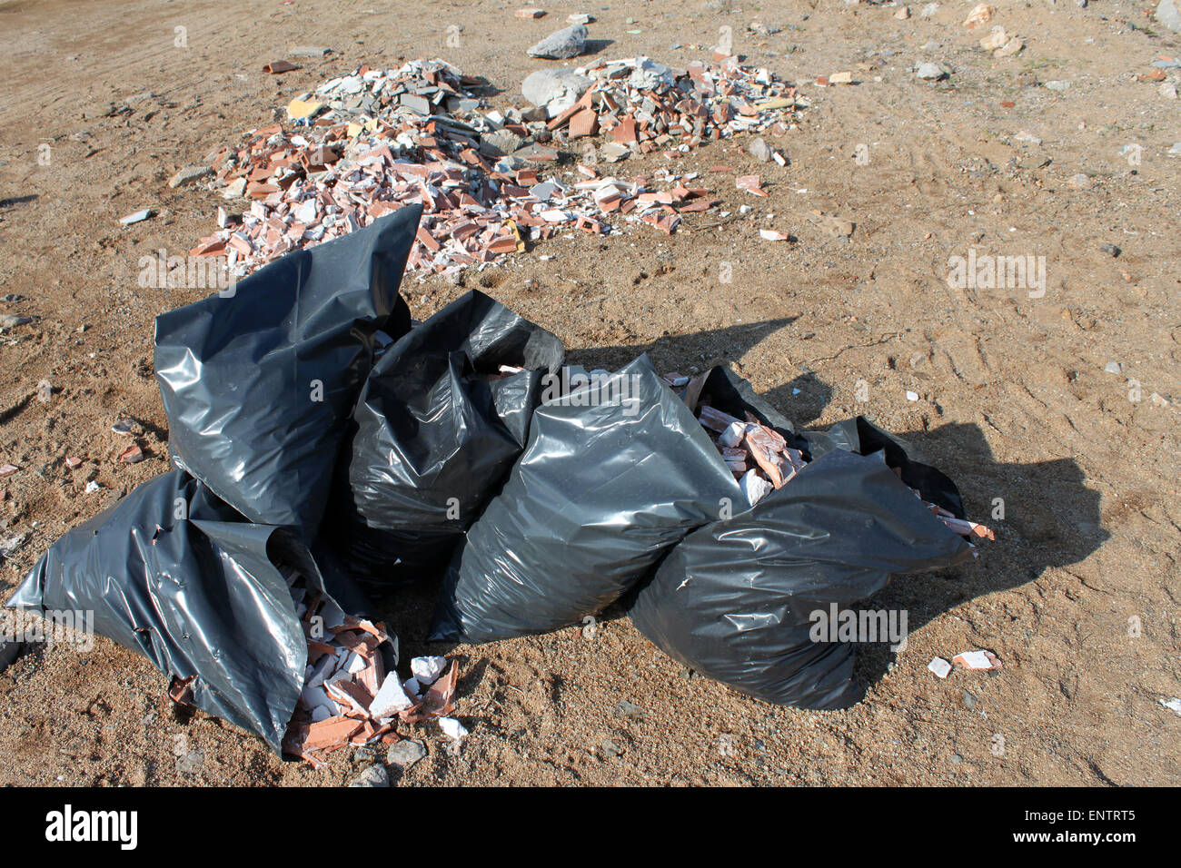 Bags of rubble dumped on beach Stock Photo Alamy