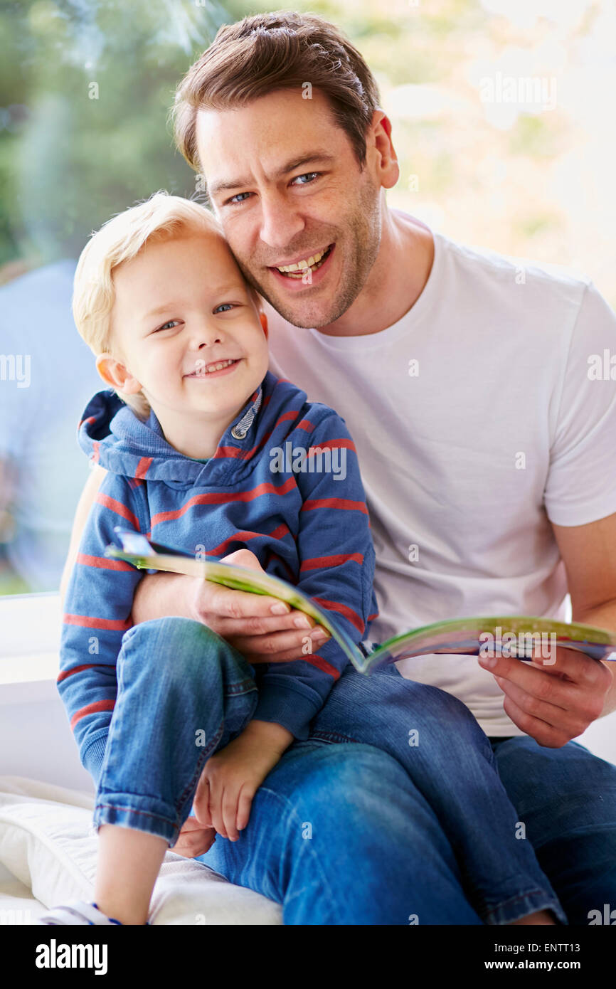 Father reading book to children Stock Photo
