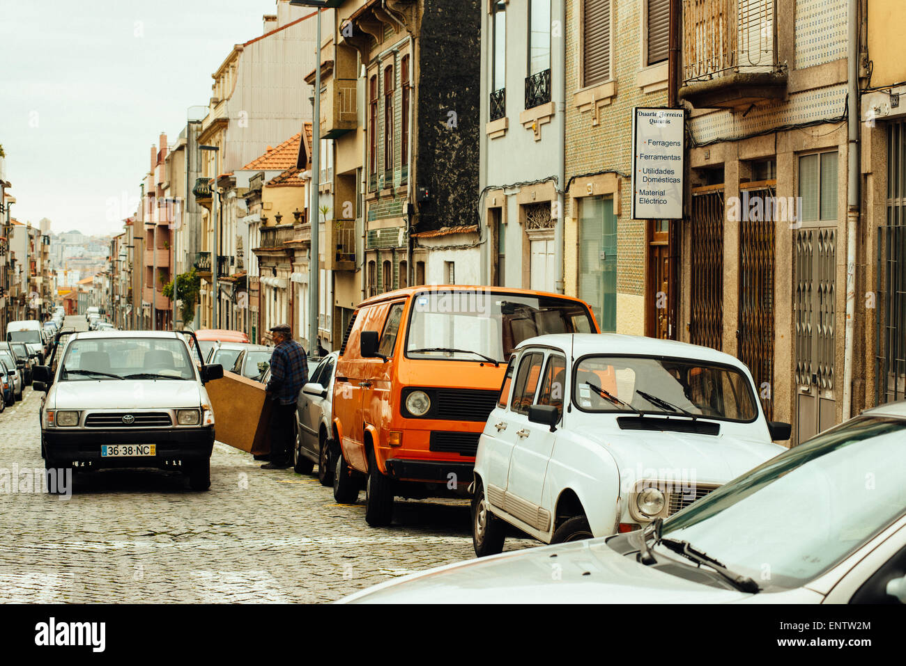 Street life in Porto, Portugal. Men load piano to car. Stock Photo