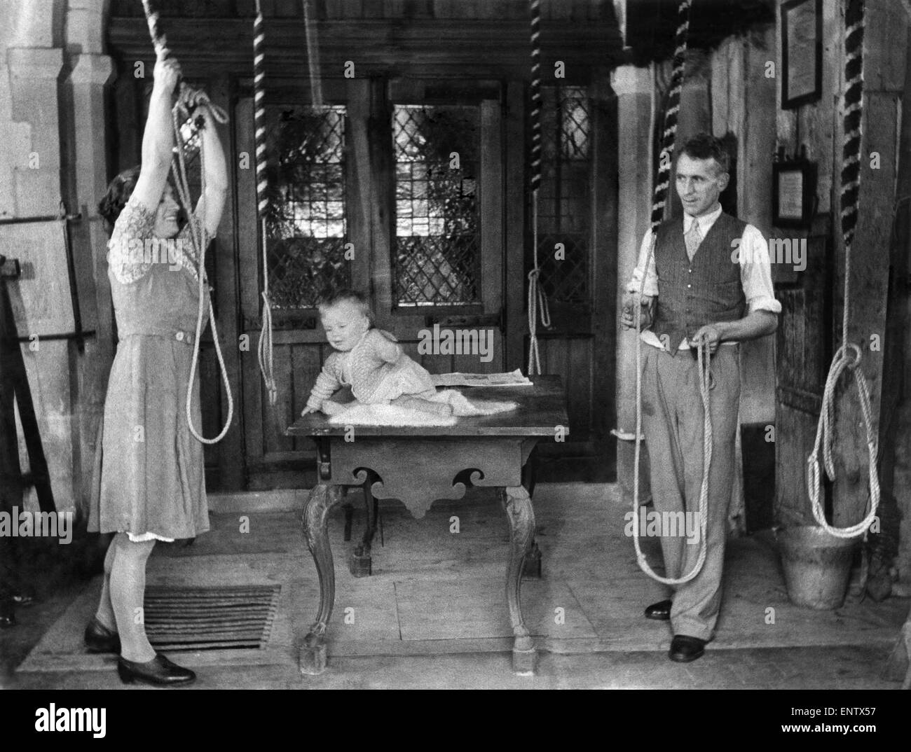 Bellringers baby at victory peal. Jimmy Booker, ten months, goes every Sunday to the village church at Shoreham, Kent with his Mum and Dad who are in the bellringing team. Today was his big day helping to ring the victory peals. 28th August 1945 Stock Photo
