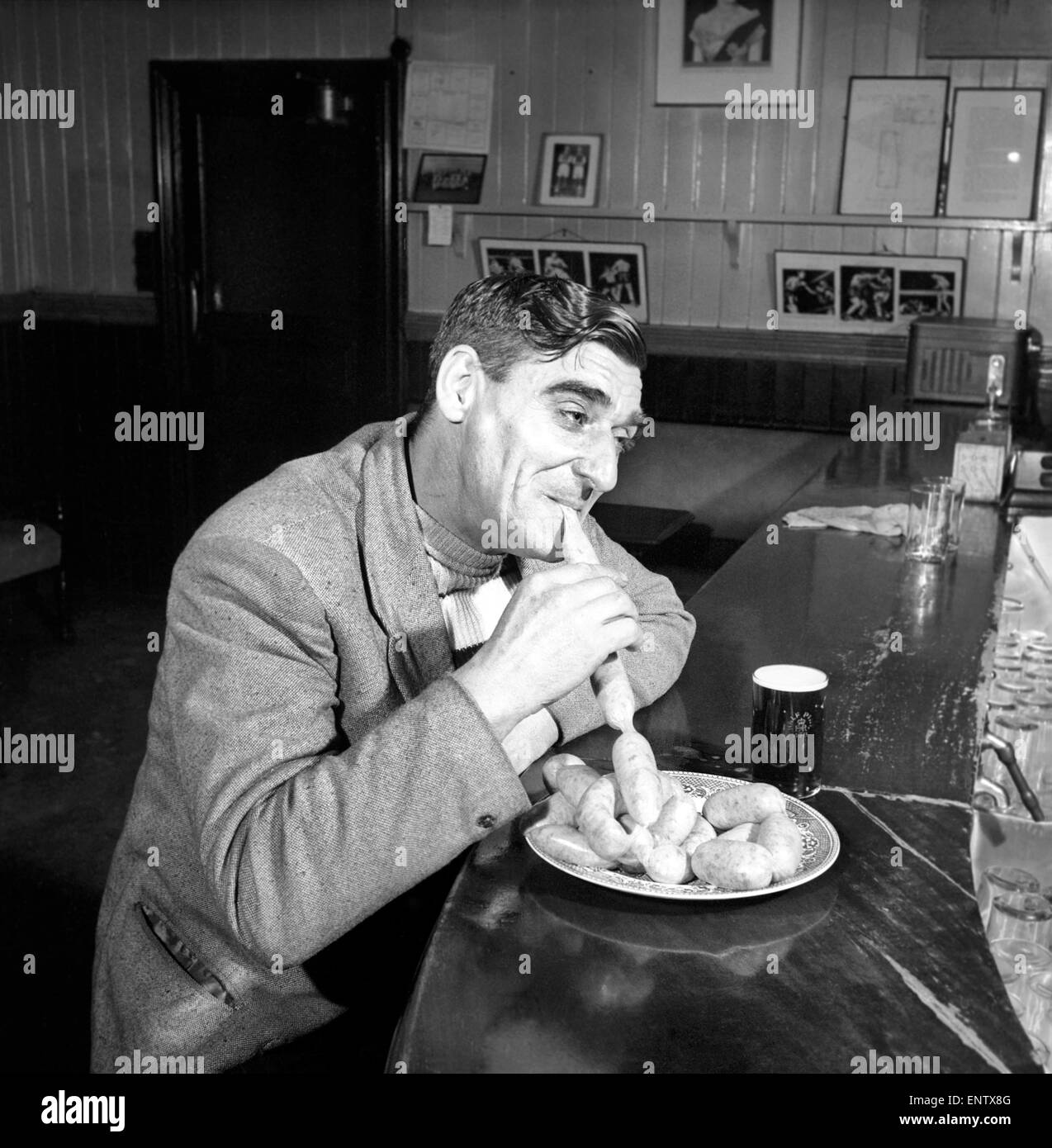 Sausage eating champion: Joe Steele of Bedlington Northumberland champion raw sausage eating champion. Circa 1965. Stock Photo