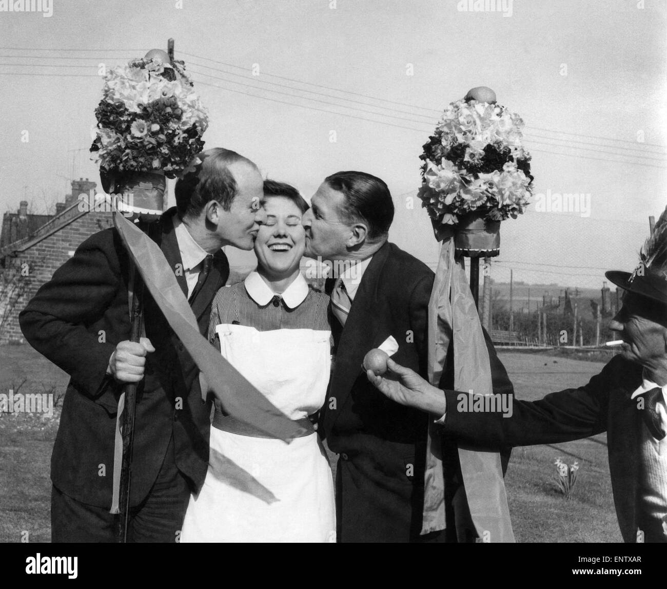 A Coin or a kiss for the Tutti-Men: The Hungerford Tutti-men exercised their traditional right today (19-4-55) and stopped women in the street, chased girls behind shop counters, and even climbed up ladders to reach them - all with a view either to extracting a coin from them, or a kiss. 19th April 1955 P029150 Stock Photo