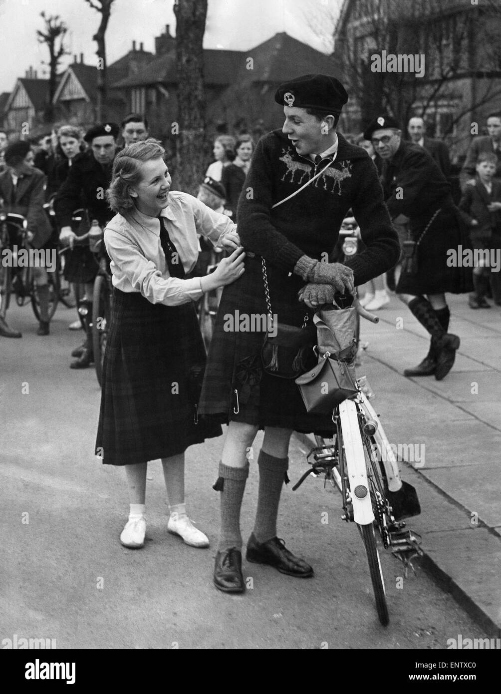 Mr. Gilbert Henry, Secretary of the Highlanders Cycling club at Grimsby says that they are the only all kilted cycling club in Britain. Kilts sometimes needs adjusting after several hours peddling. 28th February 1952 P033033 Stock Photo