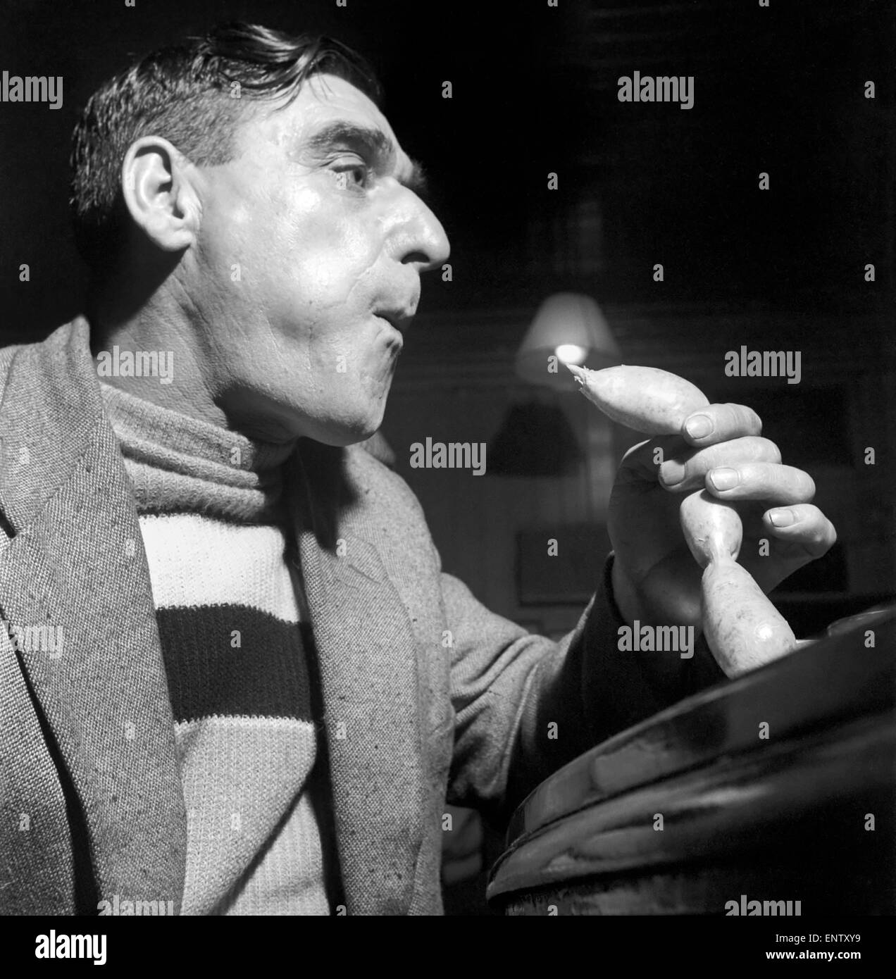 Sausage eating champion: Joe Steele of Bedlington Northumberland champion raw sausage eating champion. Circa 1965. Stock Photo