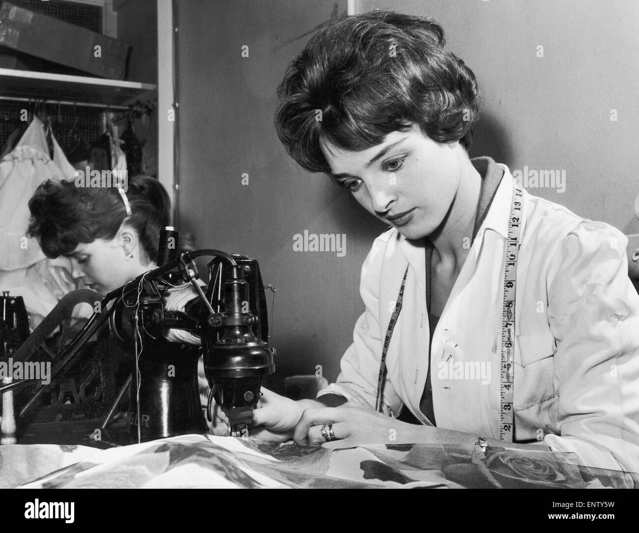 24 year old June Parkyn working as a machinist at a London fashion house. But June is more than a machinist. She is in fact a real working model, modeling clothes for the fashion house as well as making them. 24th October 1958 Stock Photo