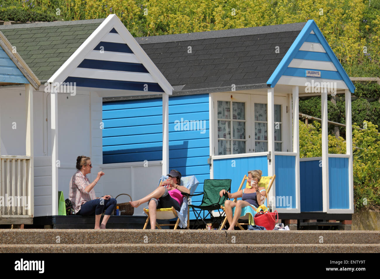 Southwold, Suffolk, England. 11th May 2015. Weather: Visitors made the most of sunny day at Southwold in Suffolk. The popular seaside resort on the east coast is famous for it's colourful beach huts, lighthouse and pier. It's unspoilt charm is a draw for families seeking a traditional British holiday. Credit:  Julia Gavin UK/Alamy Live News Stock Photo