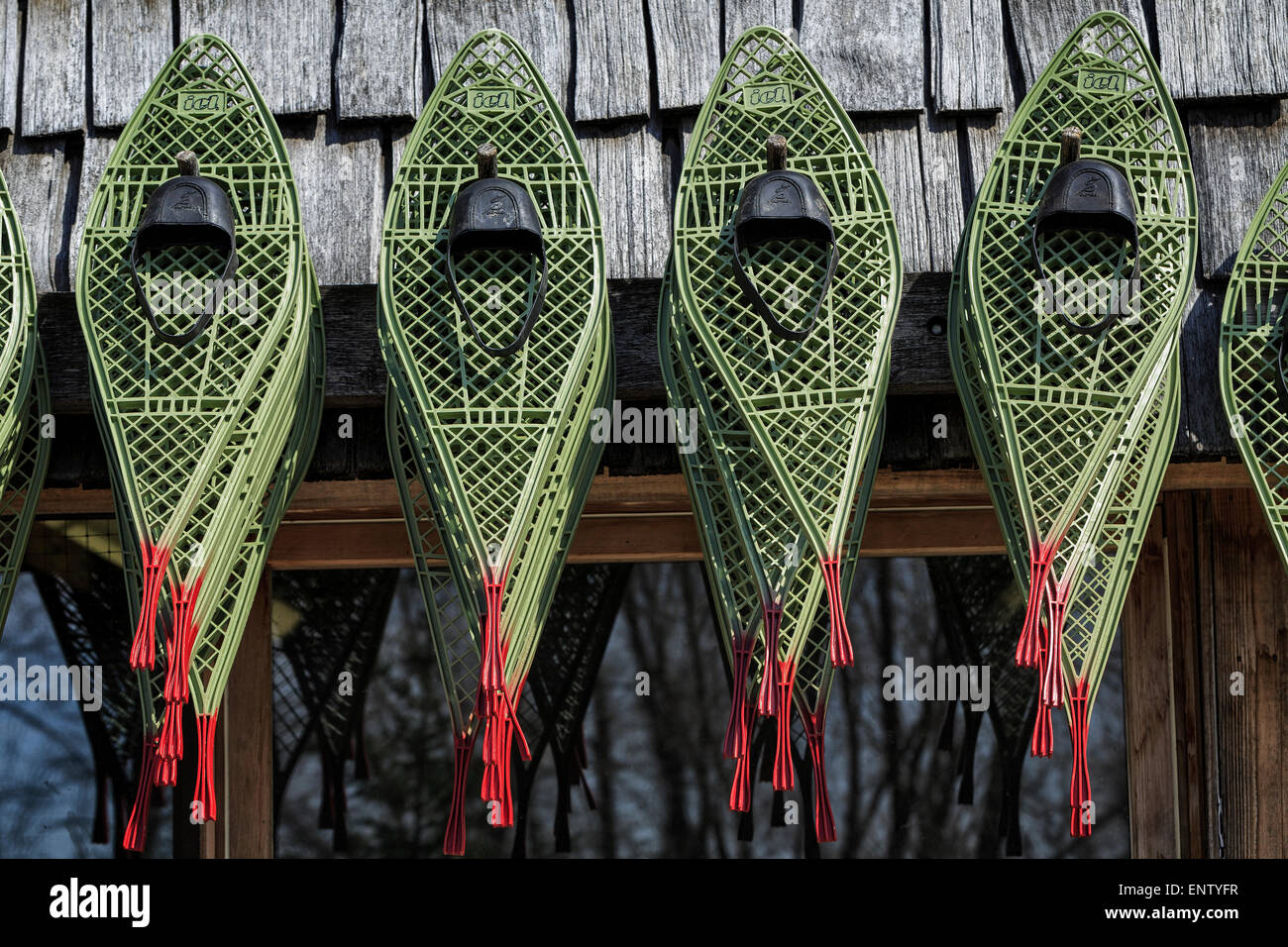 Snowshoes hanging outside Stock Photo