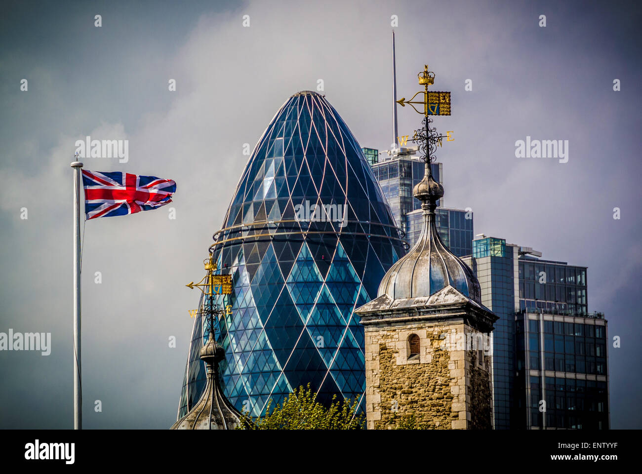The Gherkin with union jack flag and top of the Tower of London. Stock Photo