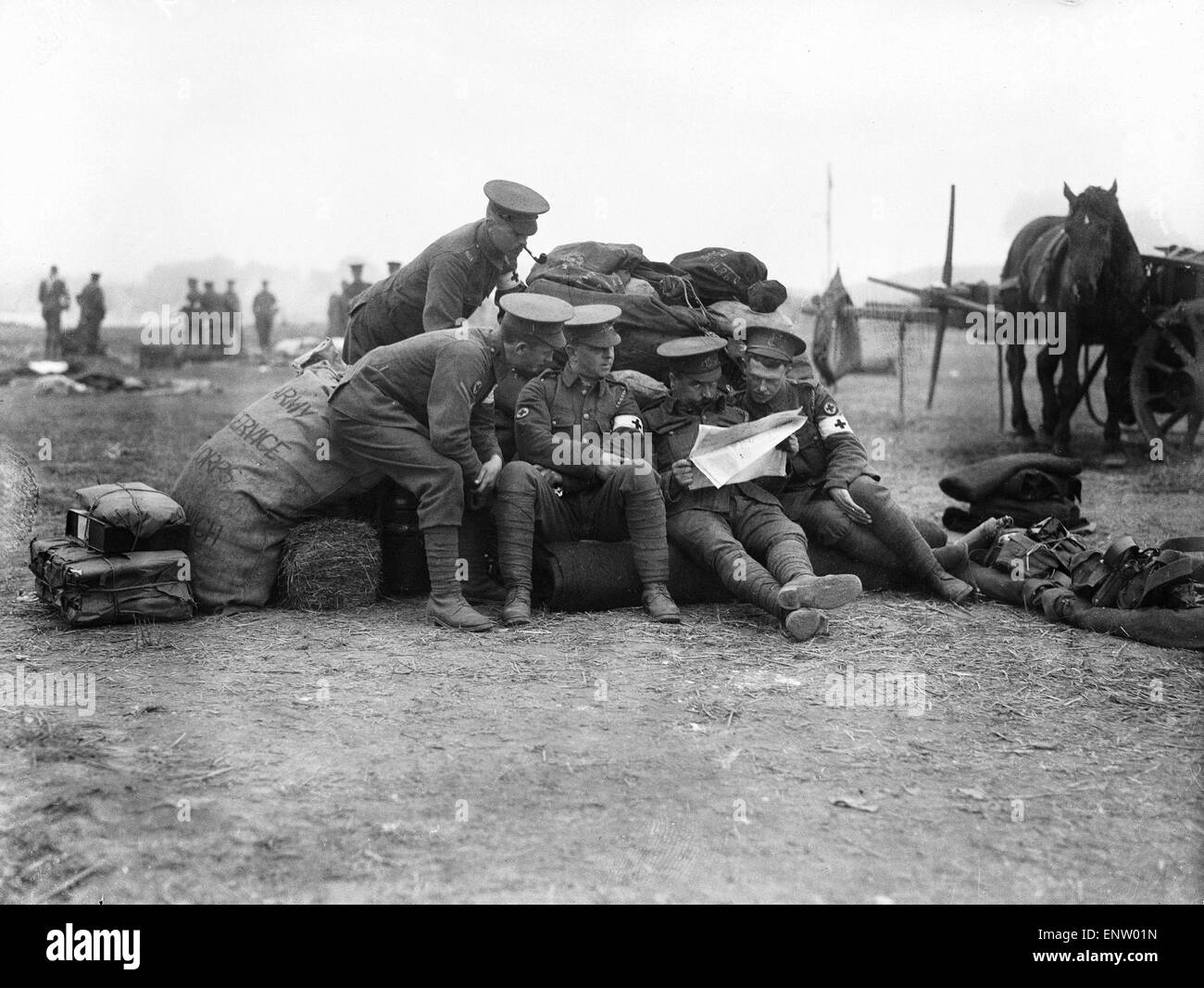 Soldiers of the Royal Army Medical Corps seen here behind the front line in Northern France taking a break and catching up with news from home. 2 September 1914 Stock Photo
