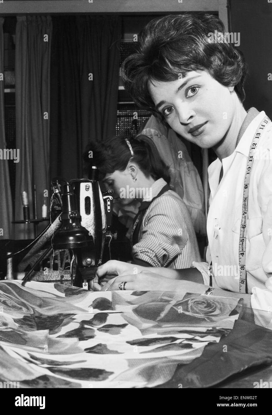 24 year old June Parkyn working as a machinist at a London fashion house. But June is more than a machinist. She is in fact a real working model, modeling clothes for the fashion house as well as making them. 24th October 1958 Stock Photo