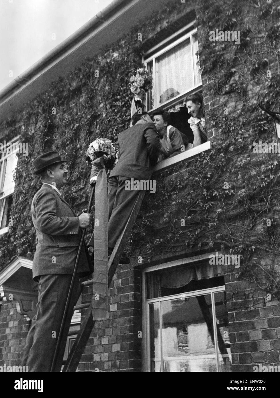 Hungerford Tutti-Men's Hocktide privilege. The right to kiss the prettiest girls of the town was claimed by the Tutti-Men of Hungerford, Berkshire, during the Annual Hocktide Festival. After the Hocktide Court, the Tutti-Men go to collect their dues and at every house where they are refused the penny, they may claim a kiss from the prettiest girl on the premises. Tutti-Men kissing girls at the top of a ladder, which they use to get to people in upstairs rooms. 30th April 1946 P029066 Stock Photo