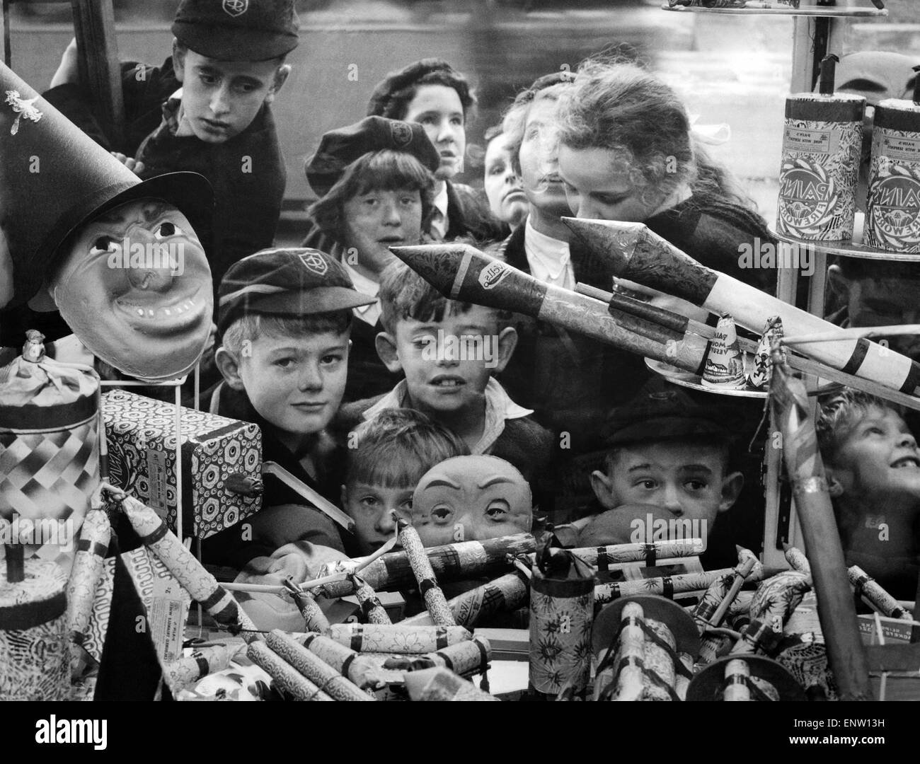 A jumble of small faces peer at a pile of very big bangers. You can just imagine the fun these Caversham children will have on Bonfire Night. October 1959 P029085 Stock Photo