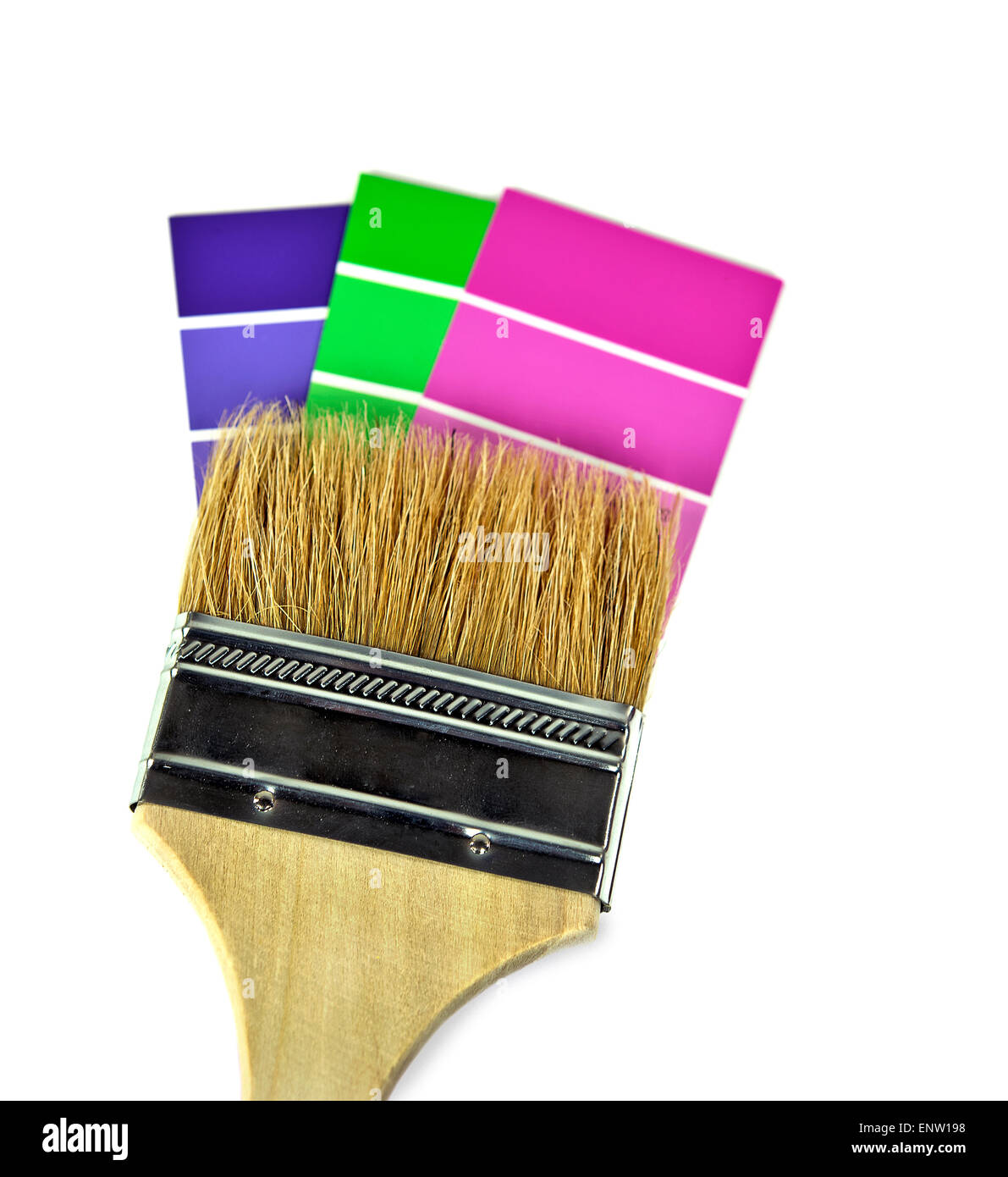 Paint brush on colorful paint chips isolated on white. Stock Photo