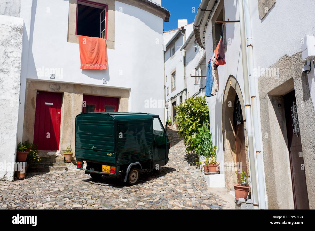 Castelo de Vide Alentejo Portugal Fiat Apecar small van parked in narrow steep cobbled street with typical white houses Stock Photo