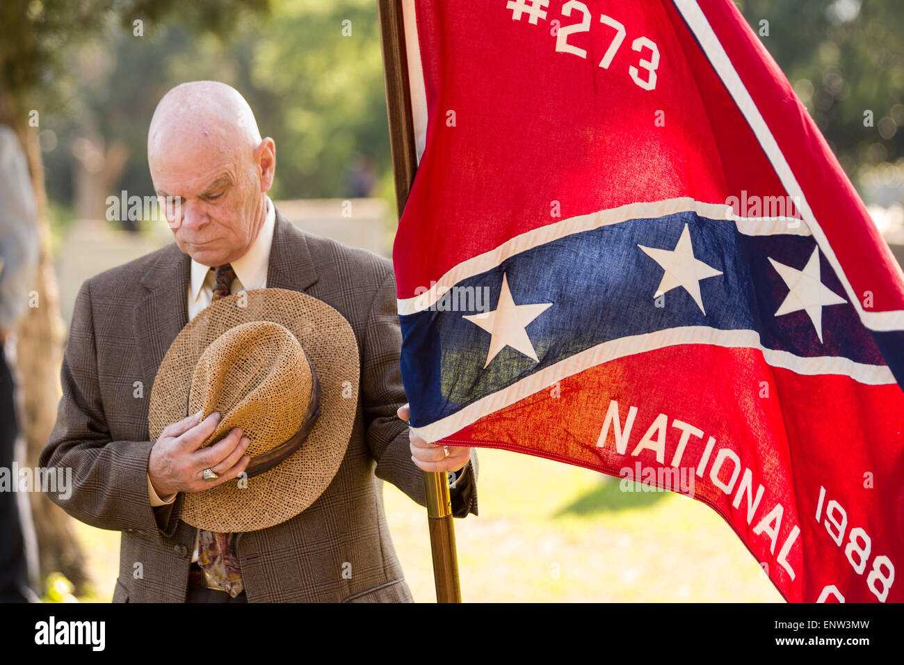 A Civil war descendant gathers holding flags during a service at