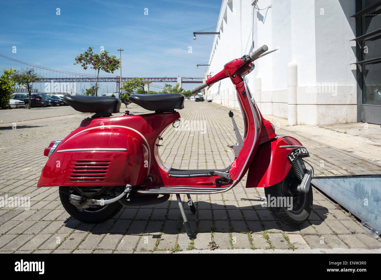 Red Vespa moped parked in Lisbon Portugal Stock Photo