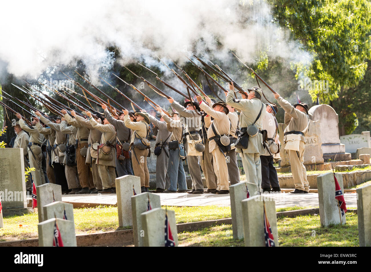Civil war re-enactors in period costume fire their rifles in honor during a service at Elmwood Cemetery to mark Confederate Memorial Day May 2, 2015 in Columbia, SC. Confederate Memorial Day is an official state holiday in South Carolina and honors those that served during the Civil War. Stock Photo