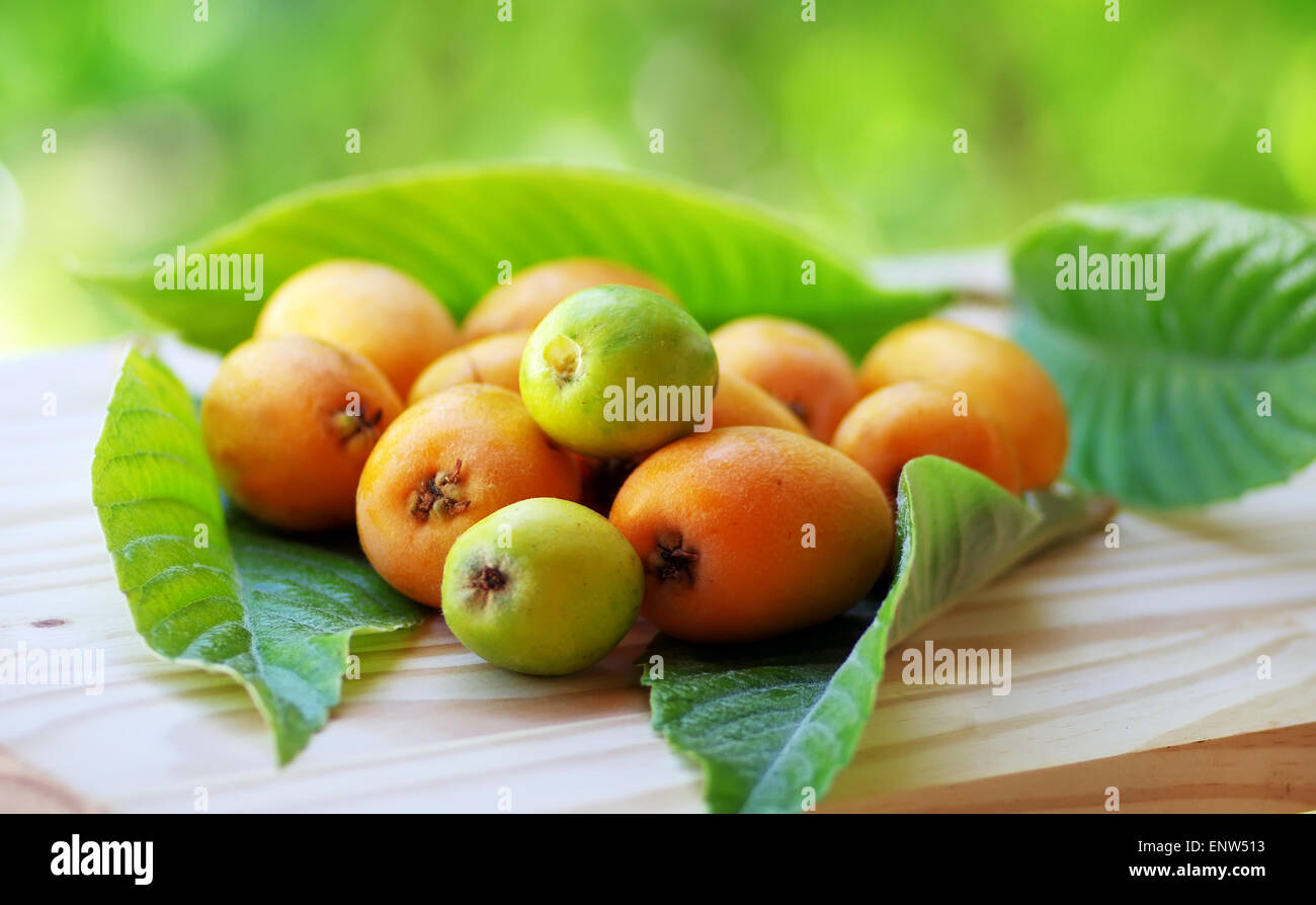 Mature and flavorful Loquats with green leaf Stock Photo