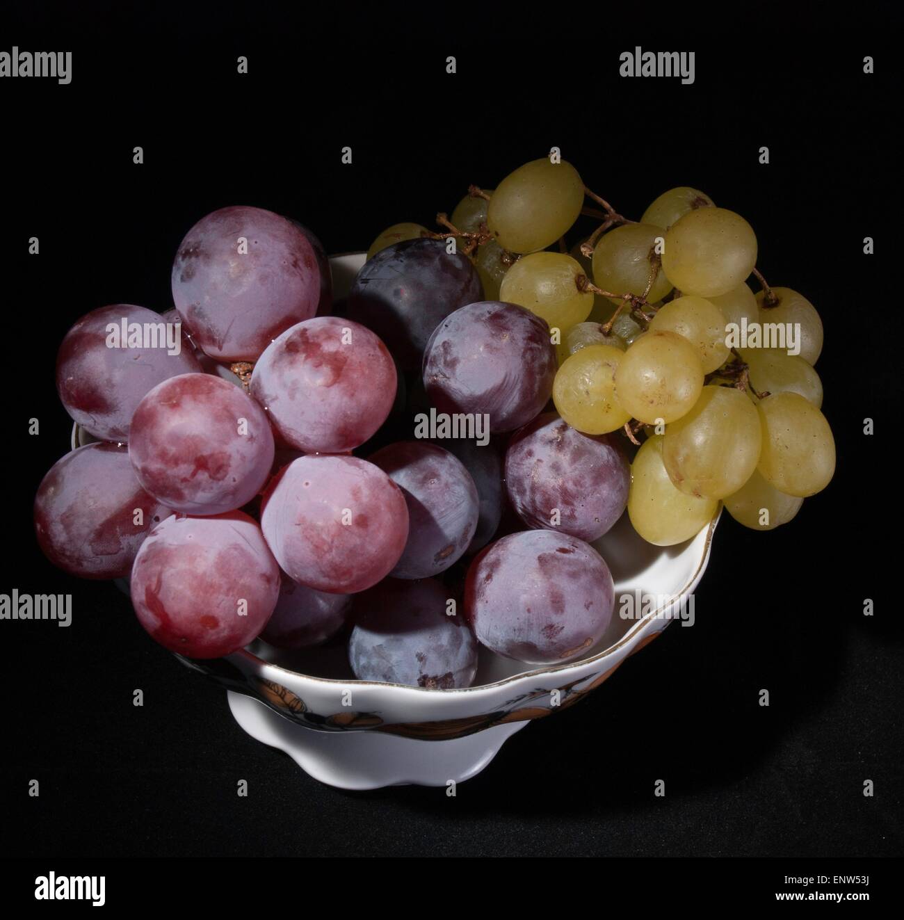 vase with grapes on a black background Stock Photo - Alamy