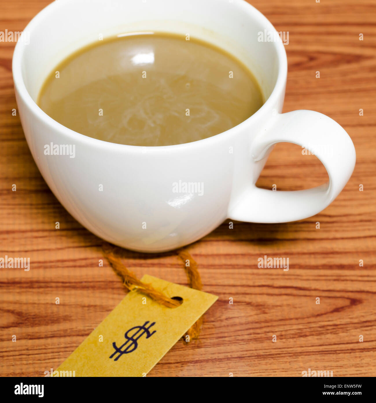 coffee cup with price tag on wood background Stock Photo