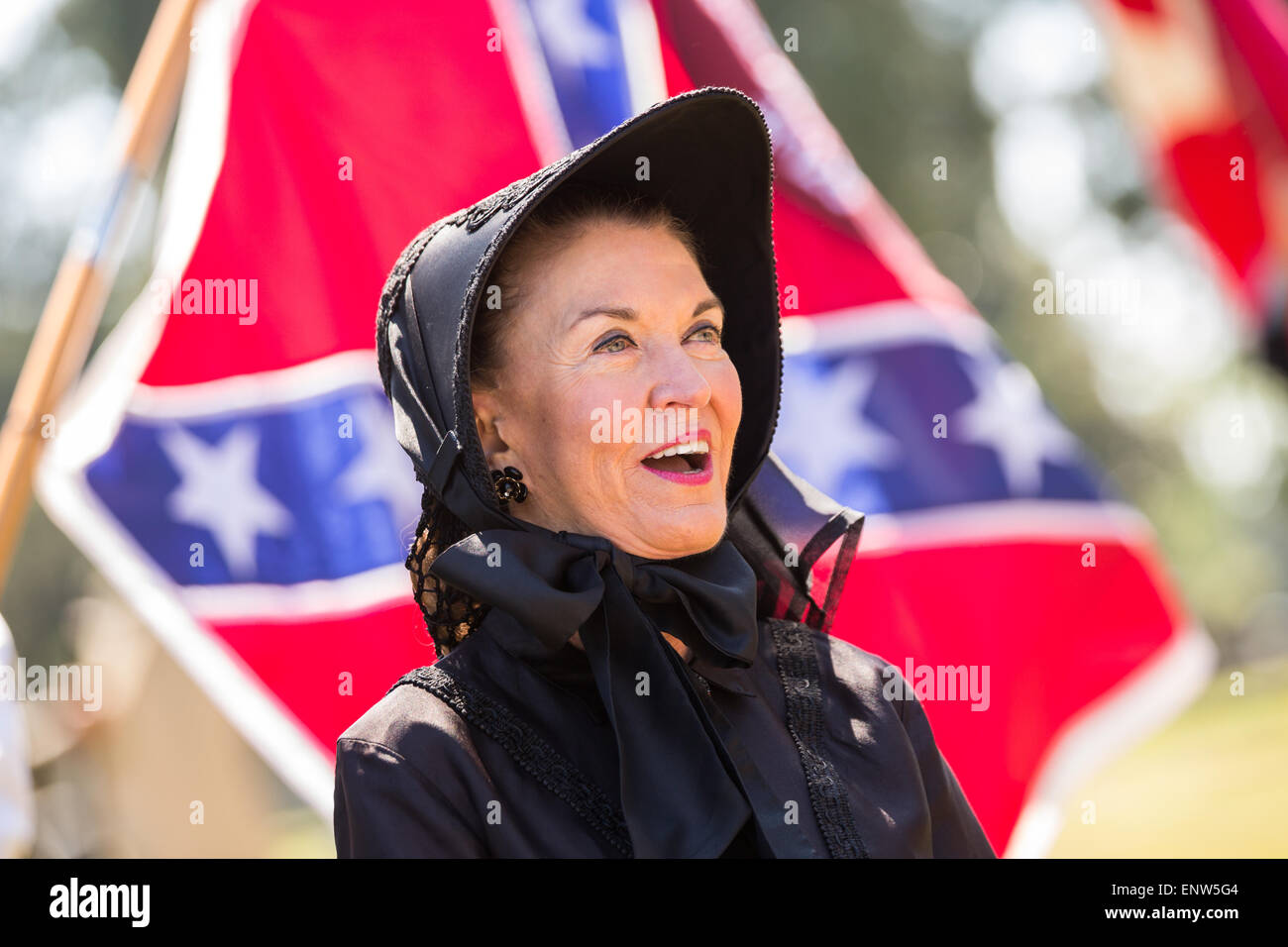 A woman dressed in civil war mourning costume sings Dixie during a