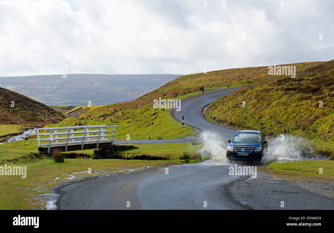 Car driving through watersplash, Swaledale, Yorkshire Dales National